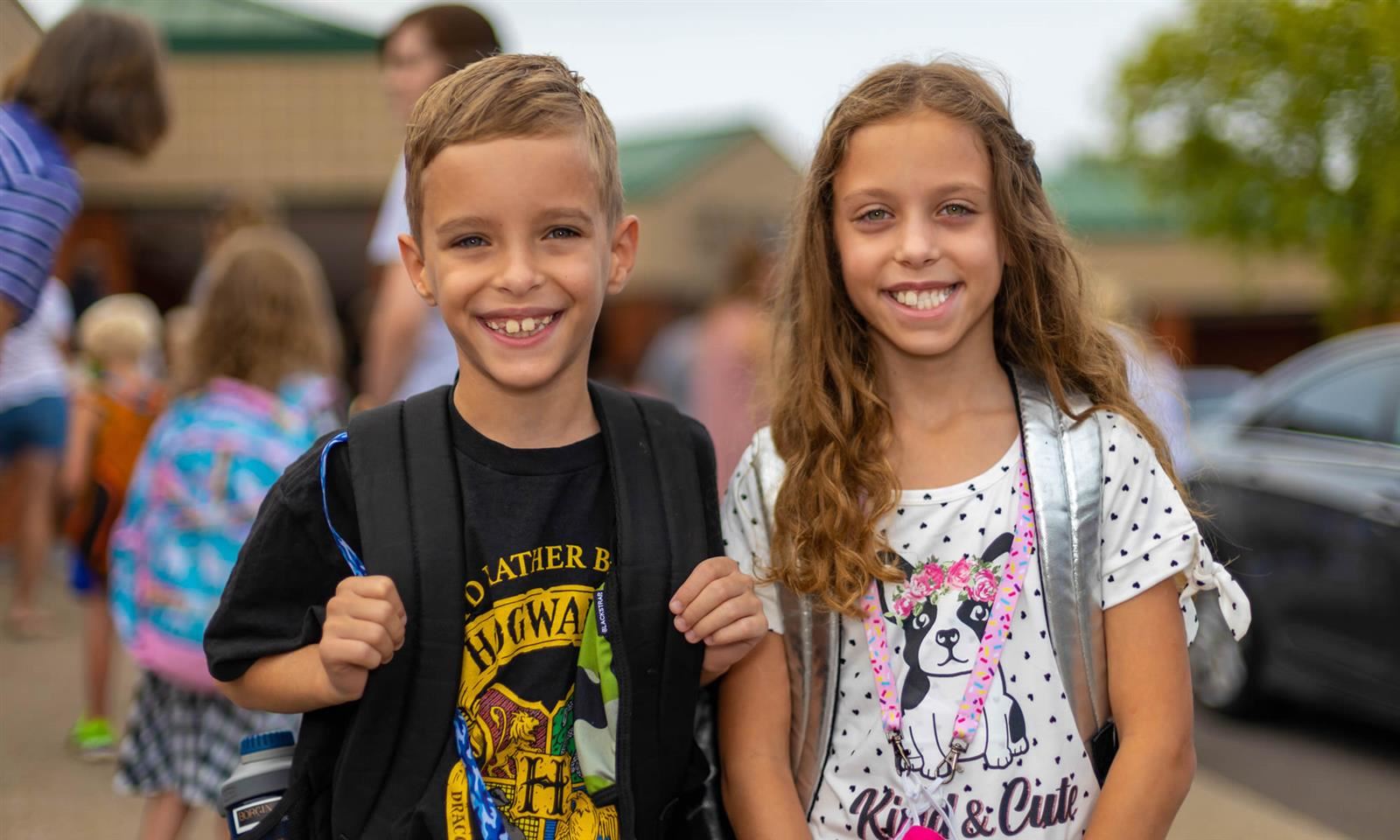Two students smile